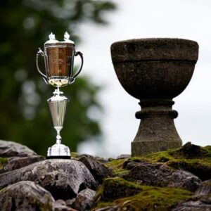 A trophy next to a stone pillar