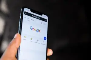 Person searching google on mobile phone