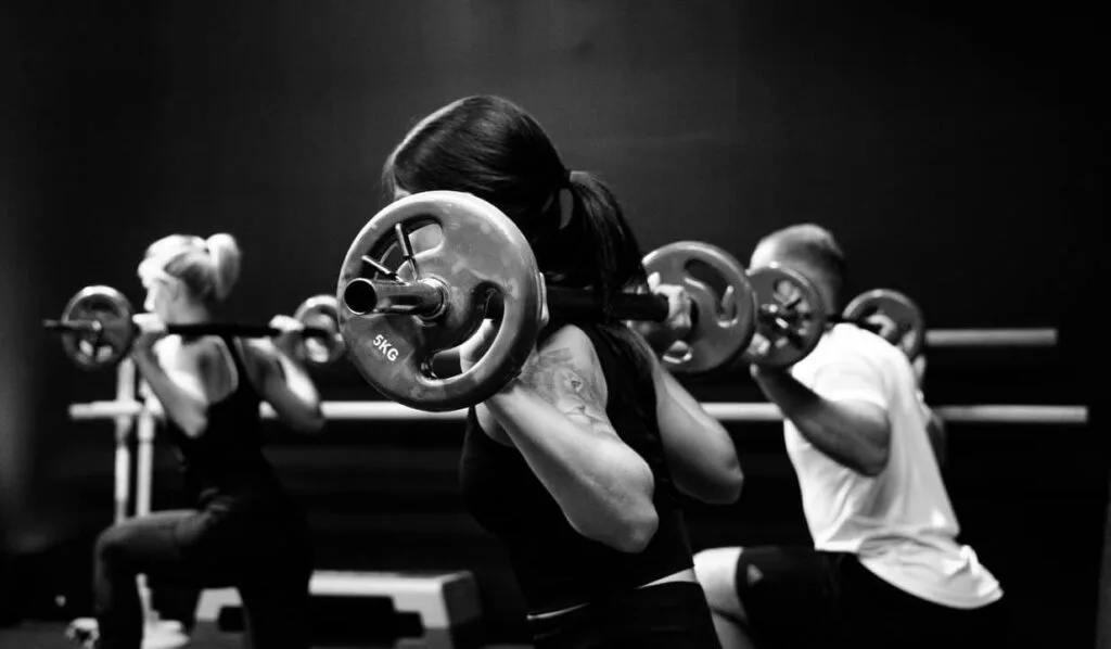 people lifting weights in a fitness class